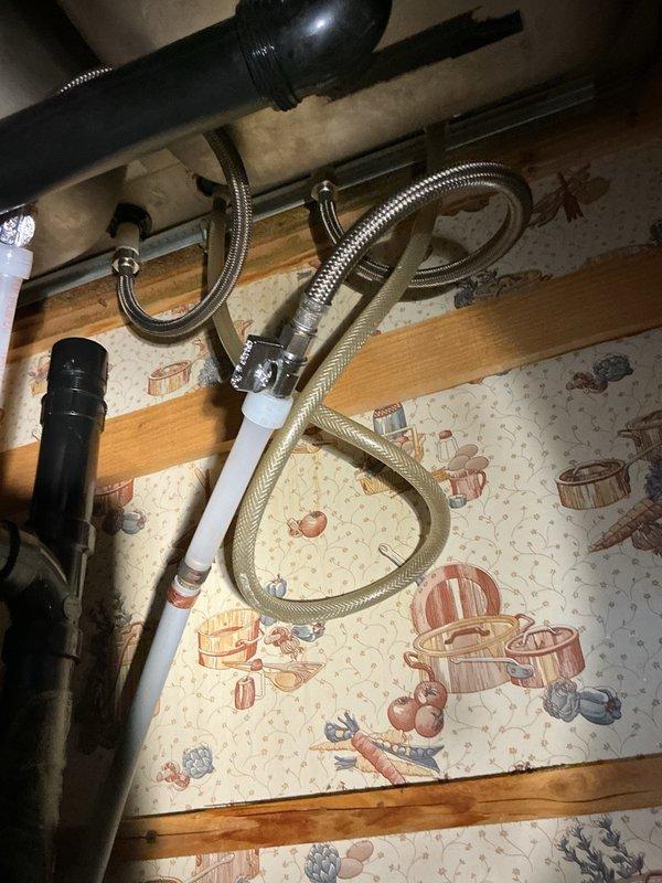 Responded to a water leak emergency underneath a kitchen sink where the supply line was actively leaking and pooling water. The existing plumbing configuration lacked individual shut-off valves at the fixture, requiring the main water supply to the home to be shut off. Installed new angle stop shut-off valves and replaced the deteriorated supply lines with braided stainless steel flexible connectors to both hot and cold water supplies serving the kitchen sink. Upon completion, restored water service and performed a thorough leak inspection to verify all connections were secure and watertight with no signs of dripping or moisture accumulation.