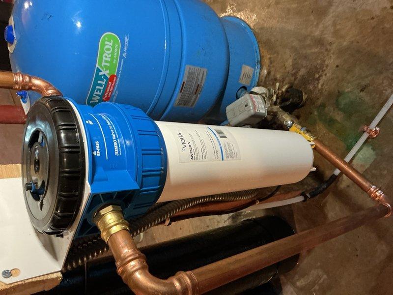 Responded to low water pressure complaint affecting multiple fixtures following recent water treatment system installation. Diagnosed plugged iron filter cartridge (RFFE20-BB) as cause of reduced flow throughout plumbing system. Replaced defective iron filter cartridge under warranty, restoring proper water pressure and flow to all fixtures.