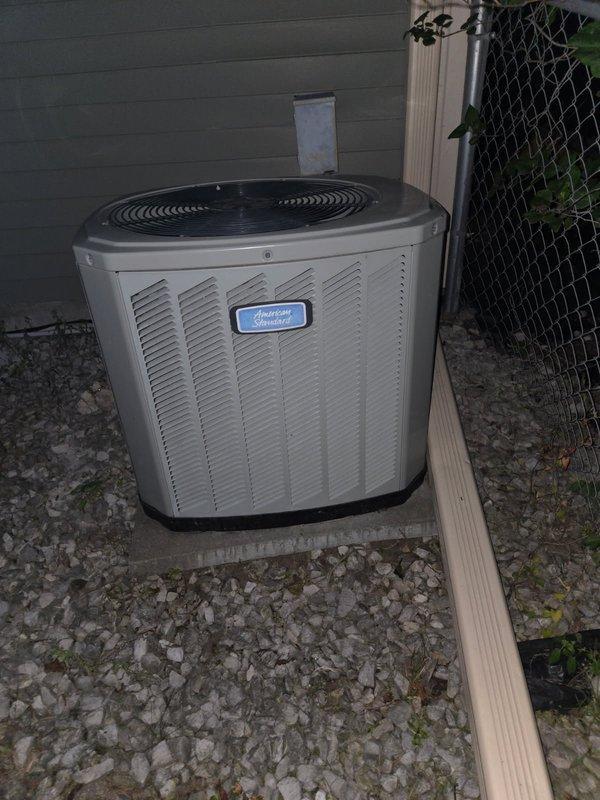 Responded to no cooling complaint on 13-year-old American Standard air conditioning system. Upon arrival, found unit completely inoperative. Diagnosed and confirmed failed capacitor as primary failure point. Replaced capacitor and restored system to operational status. 

During system testing, identified condenser fan motor actively leaking oil, indicating imminent bearing failure. Amp draw readings on compressor measured significantly high, suggesting internal wear and reduced efficiency. Noted both components are in declining condition and current repair constitutes temporary solution only.

Performed courtesy inspection of heating system and discovered critical safety issue: cracked heat exchanger on furnace, specifically above high limit switch on top right cell. Combustion analysis confirmed carbon monoxide leakage during furnace operation. Immediately advised of dangerous condition requiring urgent attention.

System currently cooling but multiple components at end of service lif