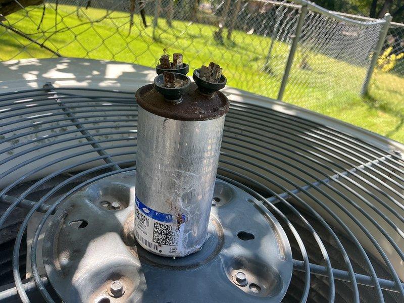 Responded to no cooling complaint on 13-year-old American Standard air conditioning system. Upon arrival, found unit completely inoperative. Diagnosed and confirmed failed capacitor as primary failure point. Replaced capacitor and restored system to operational status. 

During system testing, identified condenser fan motor actively leaking oil, indicating imminent bearing failure. Amp draw readings on compressor measured significantly high, suggesting internal wear and reduced efficiency. Noted both components are in declining condition and current repair constitutes temporary solution only.

Performed courtesy inspection of heating system and discovered critical safety issue: cracked heat exchanger on furnace, specifically above high limit switch on top right cell. Combustion analysis confirmed carbon monoxide leakage during furnace operation. Immediately advised of dangerous condition requiring urgent attention.

System currently cooling but multiple components at end of service lif