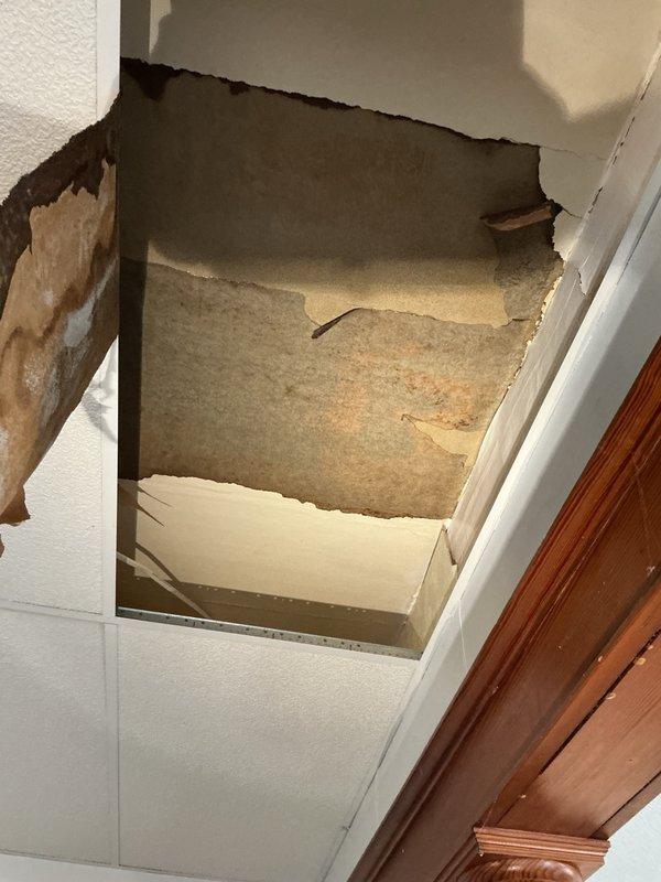 Responded to water leak emergency affecting downstairs unit with visible ceiling damage from moisture intrusion originating in upstairs unit. Upon gaining access to upstairs kitchen, identified failed cold water supply line to kitchen faucet as source of active leak. Removed defective supply line and installed new cold water supply line to kitchen faucet, restoring proper water supply while eliminating leak. Tested water hardness and verified system integrity upon completion. Documented extensive ceiling damage in downstairs unit requiring future drywall repair.
