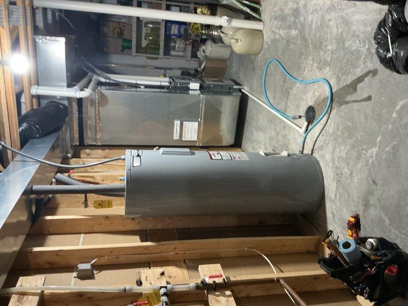 Responded to no hot water call and diagnosed a leaking water heater tank. Removed failed unit and installed new 50-gallon electric water heater with proper electrical connections, water supply lines, and code-compliant temperature and pressure relief valve discharge piping.