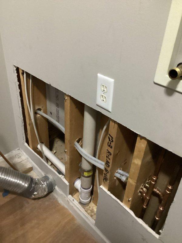 Completed installation of customer-supplied under-sink reverse osmosis water filtration system. Installed new shut-off valve and supply lines to connect the RO system to existing plumbing infrastructure. Replaced two-handle faucet on laundry tub with new fixture, including connection of hot and cold water supply lines. Accessed wall cavity to route plumbing lines and make necessary connections to existing copper and PVC pipe systems. Two technicians worked collaboratively to complete all installations, ensuring proper water flow and leak-free connections throughout the system.