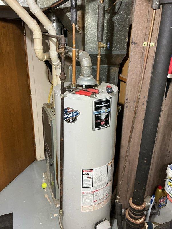 Responded to service call for Bradford White natural gas water heater not producing hot water. Upon inspection, found the high temperature limit switch had tripped, indicating an overheat condition. Reset the high limit switch and successfully restored unit operation. Tested water heater firing sequence and confirmed proper function. Unit now operating within normal parameters.