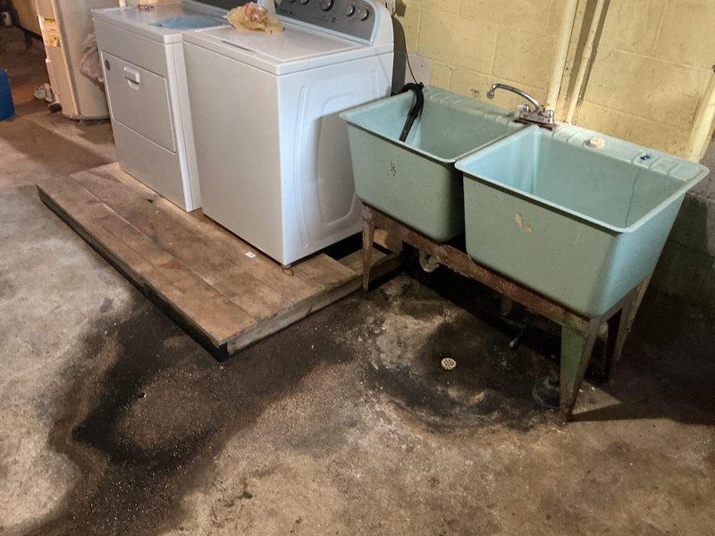 Responded to kitchen drain backup causing water to surface through basement floor drain. Upon arrival, jetted the entire kitchen drain line to clear the blockage and perform diagnostic assessment. Investigation revealed the bottom section of the drain pipe had completely rotted out and required replacement.

Relocated laundry tub, washing machine, and dryer to access the affected area. Broke out concrete flooring to expose the deteriorated drain line. Removed the failed pipe section and installed new 2" PVC drain pipe, making all necessary connections to the existing drainage system. Properly bedded the new pipe with sand for stability and support. Backfilled the excavation and poured new concrete to restore the floor surface. Conducted operational testing to verify proper drainage function and confirm the repair resolved the backup issue.