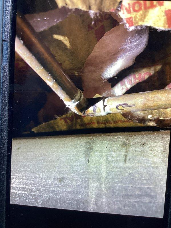 Responded to recurring water leak near main line with water shut off to home. Located source of hissing noise and identified pinhole leak at soldered 90-degree elbow fitting. Removed failed solder joint and replaced defective 90-degree elbow with new copper fitting using proper soldering techniques. Tested repair for leaks, restored water service, and confirmed system integrity. Customer declined optional replacement of approximately 20 feet of aged piping at this time.