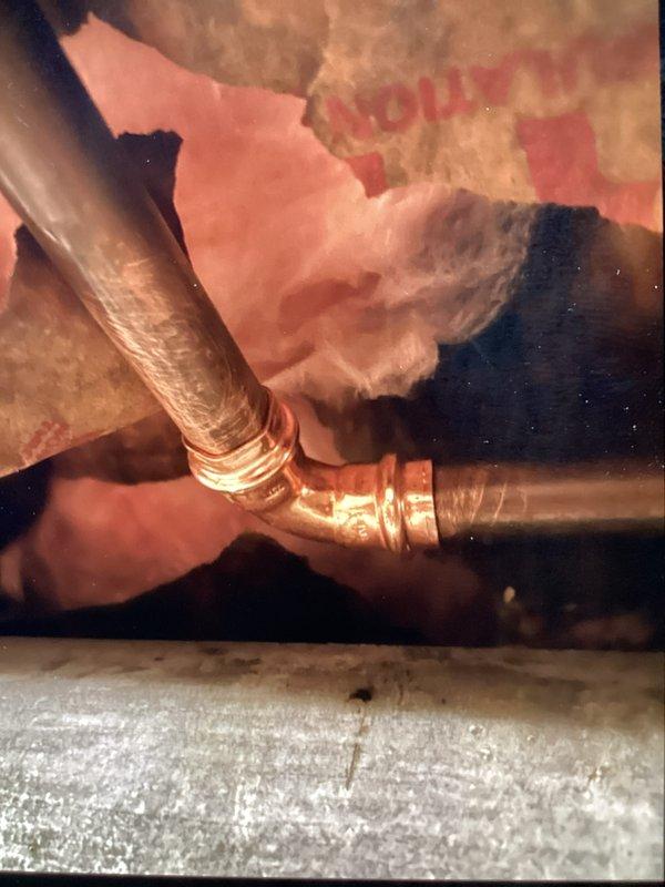 Responded to recurring water leak near main line with water shut off to home. Located source of hissing noise and identified pinhole leak at soldered 90-degree elbow fitting. Removed failed solder joint and replaced defective 90-degree elbow with new copper fitting using proper soldering techniques. Tested repair for leaks, restored water service, and confirmed system integrity. Customer declined optional replacement of approximately 20 feet of aged piping at this time.
