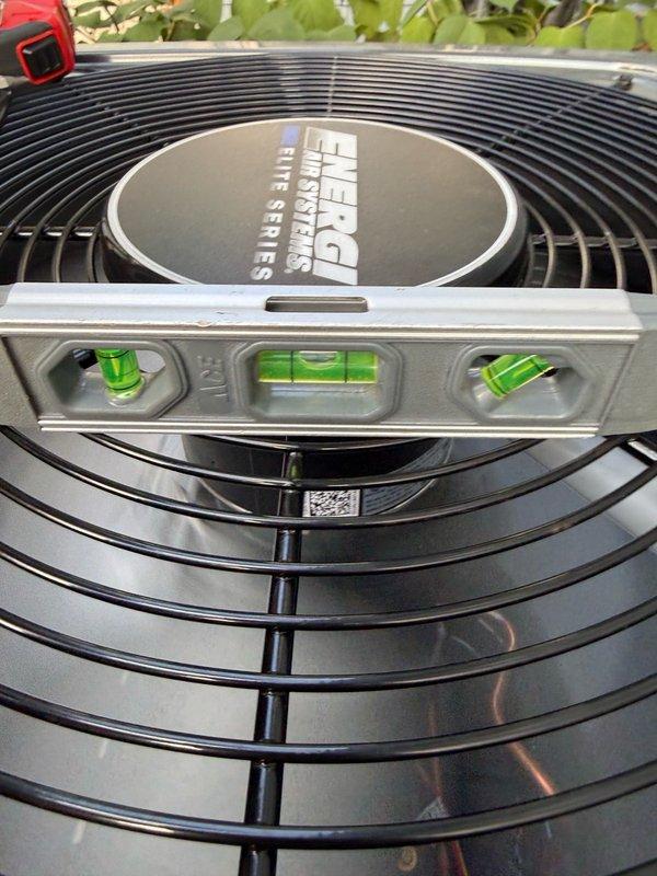Relocated Energy Systems Prime Series air conditioning condenser unit to achieve required 3-foot clearance from gas meter per safety code compliance. Verified proper level and alignment of unit after repositioning using precision leveling tools to ensure optimal operation and drainage.