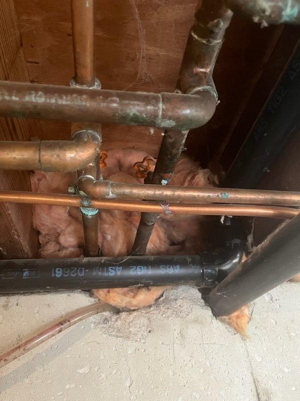 Responded to emergency plumbing call for active water leak in basement. Upon inspection, identified pinhole leak in copper water supply line running through exposed ceiling joists. Shut off water supply to affected section using existing shutoff valve. Removed damaged section of copper piping showing signs of corrosion and age-related deterioration. Installed new copper pipe section with properly soldered joints and fittings to replace compromised piping. Pressure tested repaired section to ensure leak-free operation. Restored water service and verified no additional leaks present in surrounding plumbing infrastructure.