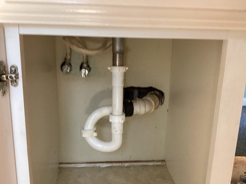 Responded to upstairs sink drainage issue where standing water would not evacuate from basin. Upon inspection, discovered both a clogged drain line and defective waste assembly with broken stopper mechanism. Removed existing drain components and installed new waste assembly with proper sealing. Performed mechanical augering of drain line to clear blockage and restore proper flow. Tested system operation to verify complete drainage and confirmed no leaks at connections.