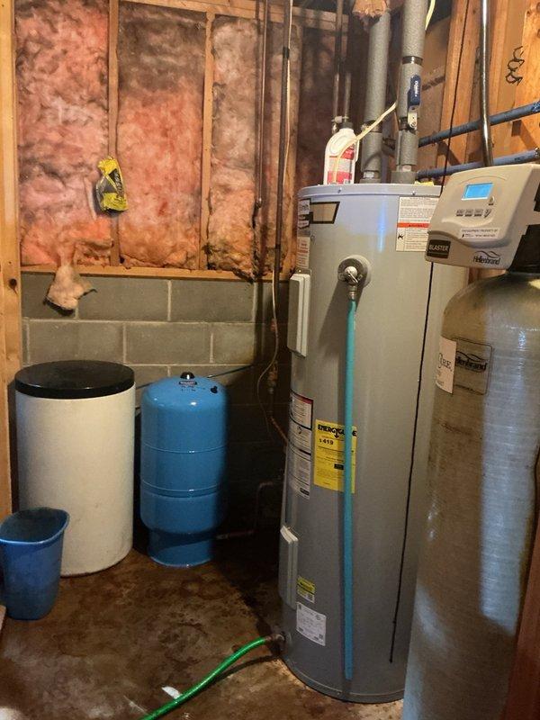 Responded to service call for leaking well pressure tank in basement. Upon inspection, confirmed pressure tank failure with active leak. Removed existing failed pressure tank and outdated galvanized tee assembly. Installed new 20-gallon well pressure tank with new tee assembly to restore proper water system function and prevent potential pump motor damage. Set pressure to 38 PSI per system specifications. Removed all galvanized fittings during installation. System tested and operational upon completion.