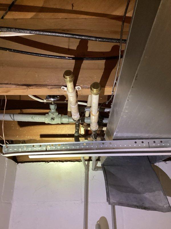 Responded to water leak in basement at abandoned washing machine hookup location. Upon inspection, found leaking shut-off valves on old CPVC plumbing lines that were no longer in service. Removed the abandoned washing machine hookup assembly and properly capped the CPVC supply lines to eliminate the leak and prevent future water damage.