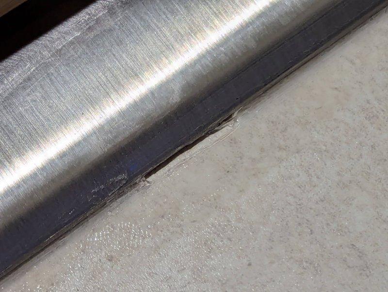 Returned to owner-occupied residential property to address incomplete caulking on previously installed kitchen sink. Upon inspection, identified several missed spots in the caulk bead that resulted in gaps and bubbles along the sink perimeter. Removed deficient caulking material, cleaned and prepared surfaces, and reapplied silicone sealant to ensure complete waterproof seal around entire sink edge. Verified proper adhesion and eliminated all gaps to prevent water intrusion and ensure professional finish.