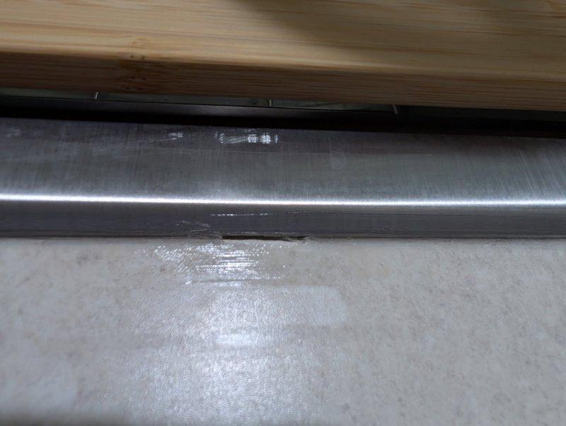 Returned to owner-occupied residential property to address incomplete caulking on previously installed kitchen sink. Upon inspection, identified several missed spots in the caulk bead that resulted in gaps and bubbles along the sink perimeter. Removed deficient caulking material, cleaned and prepared surfaces, and reapplied silicone sealant to ensure complete waterproof seal around entire sink edge. Verified proper adhesion and eliminated all gaps to prevent water intrusion and ensure professional finish.