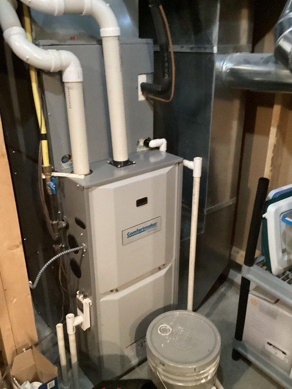 Responded to service call for non-functional water heater with confirmed leak in residential basement. Upon arrival, unit had already been drained by customer. Performed assessment and confirmed water heater was beyond repair due to active leak. Removed existing failed tanked water heater including disconnection of copper supply lines, hot water outlet piping, and all associated fittings. Installed new replacement tanked water heater in same location, securing unit with proper metal strapping per code requirements. Connected copper piping to inlet and outlet ports using appropriate brass fittings and compression connections. Verified proper integration with existing EXTROL expansion tank and pressure relief system. Tested all connections for leaks, filled tank, and restored hot water service to residence. Cleared work area and removed old unit from premises. System operational and performing to manufacturer specifications upon completion.