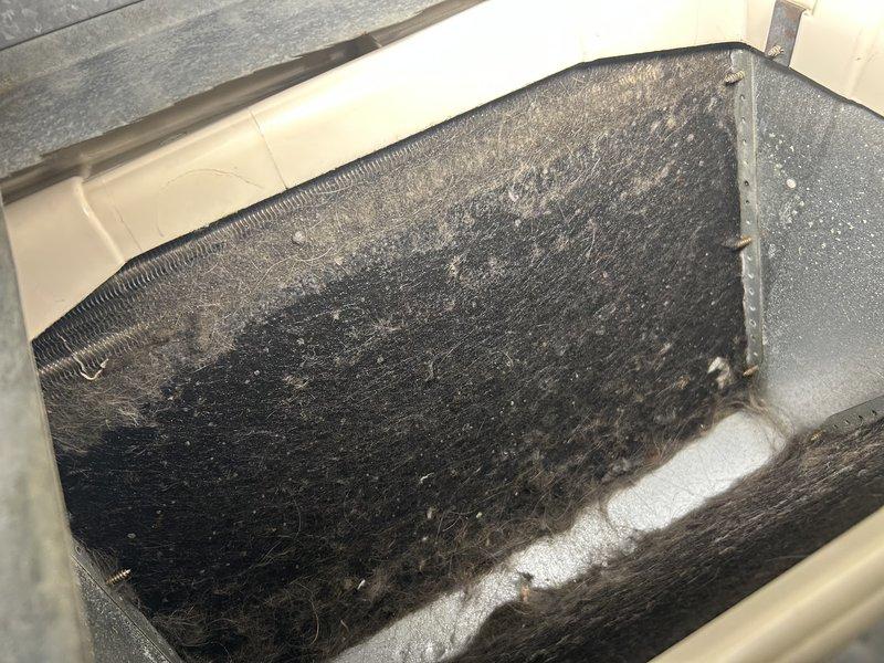 Responded to no cooling complaint with system freezing up. Upon inspection, found heavily soiled evaporator coil, blower wheel, and secondary drain pan with significant dust and debris accumulation, contrary to initial report that coil was clean. Performed thorough cleaning of evaporator coil, blower wheel, and secondary drain pan to restore proper airflow. After cleaning, connected manifold gauges and tested system operation. Unit now operating without freezing, providing adequate cooling. System appears slightly low on refrigerant charge but is functional. Homeowner elected to monitor system performance and defer refrigerant charge at this time.