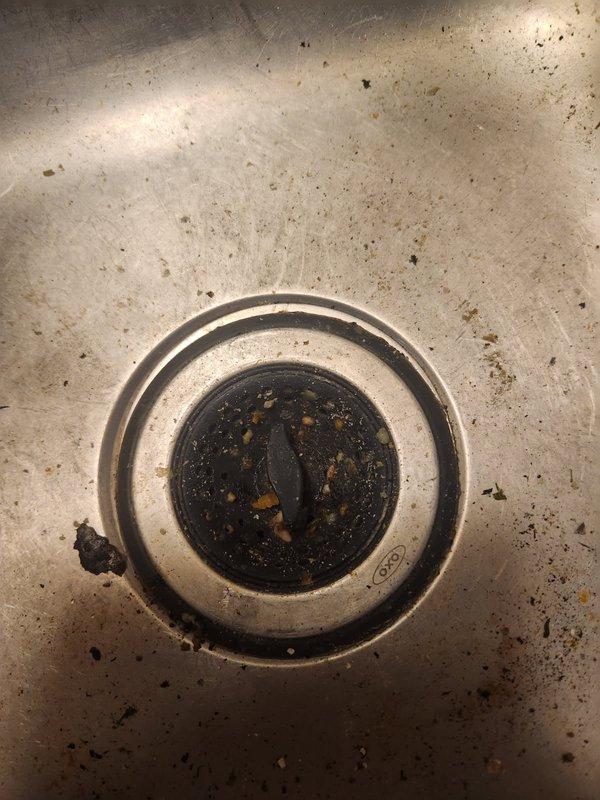 Responded to kitchen sink backup affecting dishwasher and garbage disposal in townhome unit. Upon arrival, found water accumulating in both the sink basin and dishwasher due to shared drainage system backup. Performed diagnostic assessment and determined blockage was located 10 to 15 feet downstream in the drain line.

Utilized drain cable to clear obstruction, breaking up accumulated soap scum, solidified chemical drain cleaner residue, and food debris causing the stoppage. Mechanically removed blockage material through cabling process. Flushed drain line thoroughly with sink water to ensure complete removal of debris and verify proper flow rate. Reassembled all drain components and conducted operational testing of the system.

Verified kitchen sink drains freely with no standing water, dishwasher connection draining properly, and garbage disposal operating without backup. All fixtures restored to normal function at time of completion.