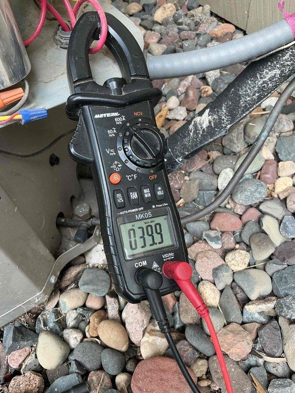 Responded to no cooling complaint on approximately 10-year-old air conditioning system. Upon arrival, unit was humming but outdoor fan would not start. Diagnosed failed dual run capacitor using clamp meter to verify amperage readings. Replaced defective capacitor with new unit meeting manufacturer specifications. Installed hard start kit to compressor to improve starting performance and extend equipment life. Tested system operation and verified proper amperage draw on all components. Unit cooling normally at time of departure.