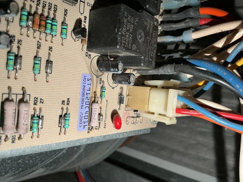 Responded to service call for air conditioning system not adequately cooling residence. Performed comprehensive AC tune-up and system diagnostic. Verified refrigerant charge at proper levels, inspected outdoor coil (clean), confirmed air filter in good condition. Measured temperature split at 14-15 degrees, which is slightly below optimal but within acceptable range.

Upon further investigation, discovered furnace blower motor failing with visible oil leakage, likely reducing airflow velocity across evaporator coil and contributing to diminished cooling performance. Inspected furnace control board and found burn marks indicating electrical stress. Conducted heat exchanger inspection and identified multiple cracks around eyelets, creating dangerous carbon monoxide leak when system operates. Tagged furnace as unsafe to operate due to CO hazard.

Photographed control board showing burn damage on components and documented heat exchanger condition. Advised immediate furnace replacement requ