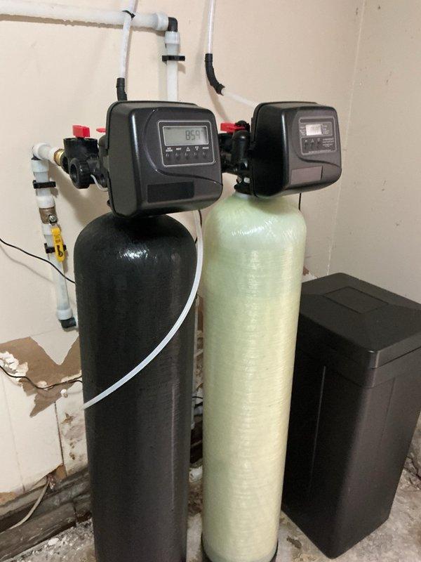 Responded to callback for second opinion on water treatment system performance issues. Upon inspection, confirmed well supply insufficient to maintain flow demand for neutralizer system. Observed Pentair Wellmate pressure tank and dual-tank water treatment system with digital control valves. Determined issue related to well pump depth and water recovery rate rather than recently replaced equipment. Recommended contacting well service contractor to evaluate pump placement and potentially lower pump assembly to access deeper water table for improved flow capacity.