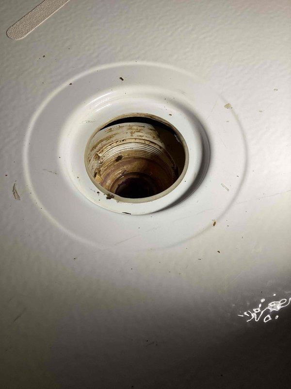 Responded to a callback for an unresolved leak originating from an upstairs shower in a townhome. Upon inspection, discovered the shower was draining slowly and the shower drain assembly had become loose from the shower base. Snaked the shower drain line to clear the obstruction and restore proper drainage flow. Reset and secured the shower drain to the shower base to eliminate the leak and ensure a watertight seal.