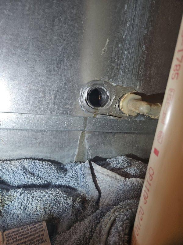 Performed comprehensive HVAC maintenance on 20-year-old system experiencing water leakage from secondary drain. Cleared plugged AC condensate drain line and addressed plugged secondary heat exchanger. Identified draft motor drawing maximum amperage, blower motor leaking oil, and improper drainage causing water discharge from auxiliary drain port. Recommended comfort advisor consultation due to multiple component issues requiring immediate attention including draft motor replacement, blower motor service, and heat exchanger evaluation.