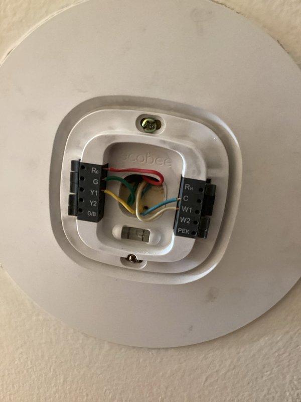 Responded to no cooling complaint on system with previous service history. Found control board receiving 26 volts but failing to energize system. Removed and reseated fuse, which restored system operation temporarily. Diagnosed intermittent control board failure causing loss of communication with thermostat. Verified five-wire thermostat configuration at ecobee smart thermostat with proper terminal connections (R, C, G, Y, W). System currently operational but control board requires replacement due to intermittent failure pattern. Provided quotes for control board replacement and complete system replacement given unit age.