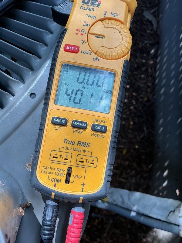 Responded to no cooling complaint on 10+ year old R410A system. Upon arrival, outdoor unit was humming but condenser fan blades were not rotating. Performed electrical diagnostics and discovered no power supply from main electrical panel to HVAC system. Traced power issue to Generac generator transfer switch control box, which was buzzing with no indicator light illuminated. Verified system ties into Generac automatic transfer system. Used digital multimeter to confirm zero voltage at unit disconnect and measured voltage readings at various test points to isolate power failure to generator control system. Customer has active warranty coverage with Generac for transfer switch equipment. Recommended contacting Generac service or licensed electrician to diagnose and repair generator control box malfunction before HVAC system can be restored to operation. Customer declined electrical service at this time and will coordinate Generac warranty service independently.
