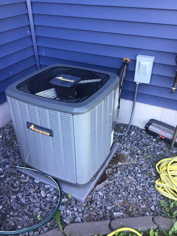 Completed comprehensive tune-up and maintenance on both 5-year-old Amana air conditioning and furnace systems, with both units operating within normal parameters. Discovered floor drain not draining properly, indicating potential septic backup issue; advised customer of findings and notified office to schedule plumber for drain evaluation and repair.