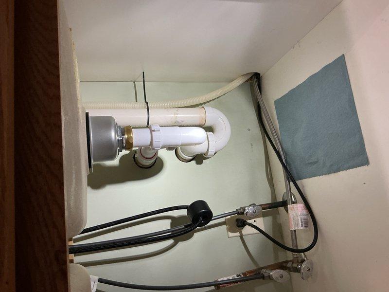 Responded to service call for leaking garbage disposal unit (6.3 amp, 1/2 HP model). Removed and eliminated the malfunctioning garbage disposal from under-sink installation, disconnected electrical and plumbing connections, and reconfigured drain assembly with standard P-trap to restore proper sink drainage functionality.