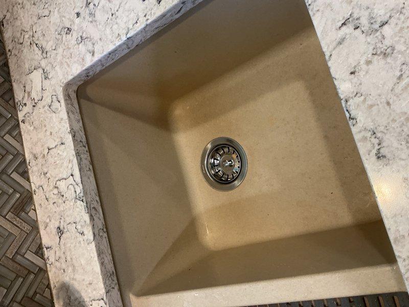 Responded to service call for leaking garbage disposal unit (6.3 amp, 1/2 HP model). Removed and eliminated the malfunctioning garbage disposal from under-sink installation, disconnected electrical and plumbing connections, and reconfigured drain assembly with standard P-trap to restore proper sink drainage functionality.