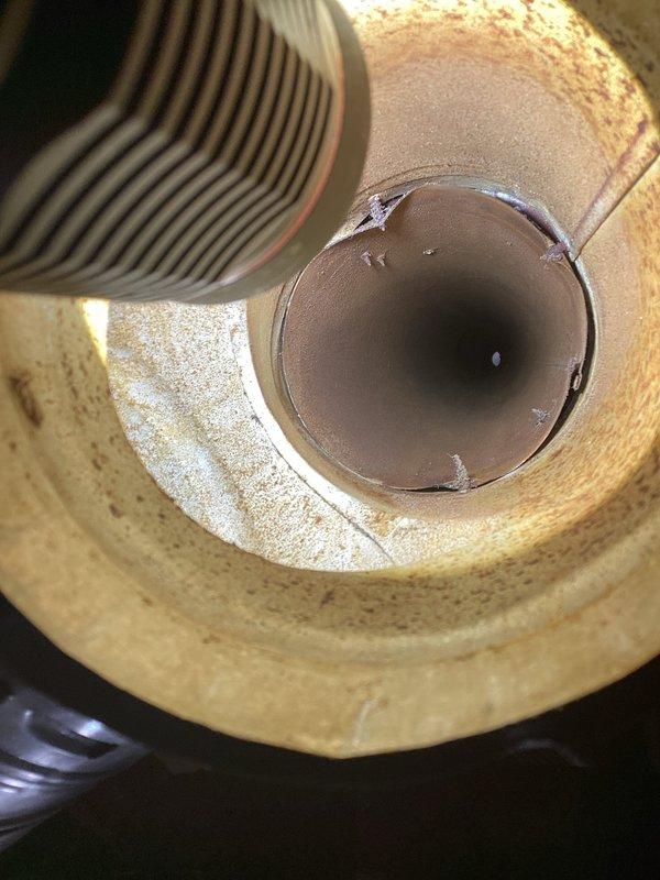Responded to emergency call for back drafting 40-gallon natural gas water heater. Upon inspection, identified 24-year-old A.O. Smith ProMax unit experiencing dangerous combustion gas spillage due to inadequate makeup air in utility room. Immediately shut off gas supply to unit for safety. Assessed draft hood and flue system, confirming improper venting conditions caused by insufficient fresh air supply. Implemented temporary solution by opening window to provide makeup air and prevent carbon monoxide hazard. Documented flue conditions and water heater installation with photographs. Advised that permanent ventilation solution required and recommended unit replacement due to age and safety concerns.