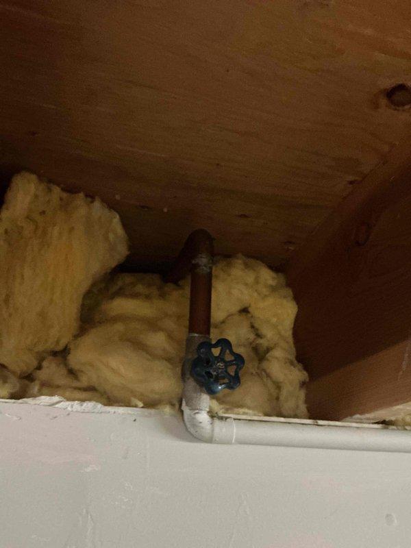 Replaced outdoor spigot with new fixture, installing shutoff valve with blue handle control for interior water isolation. Installed new PVC supply line connection and properly insulated exposed piping with fiberglass insulation to prevent freeze damage during cold weather conditions.