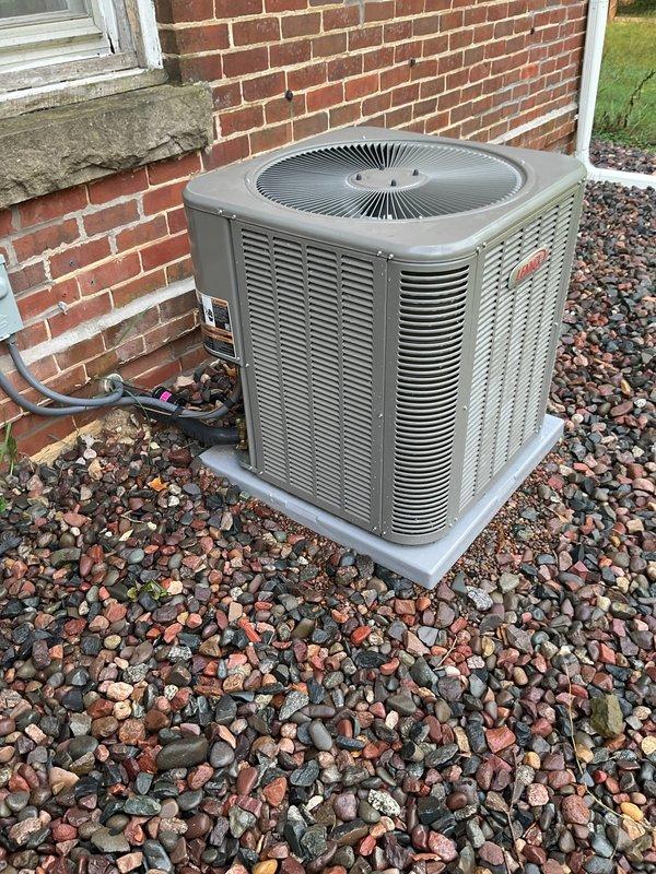 Responded to no-cool complaint on one-year-old residential AC unit reportedly tripping power and dimming lights during startup. Performed diagnostic evaluation including capacitor testing, hard start kit inspection, disconnect wiring verification, and electrical panel wiring check at main fuse box. Measured amp draw at approximately 7 amps on one leg. After weather cleared, connected manifold gauges and recorded refrigerant pressures with subcooling at 8°F and superheat at 20°F at 70°F ambient temperature. Cycled unit power multiple times with normal startup operation observed. No electrical or mechanical faults identified during service call, unit operating within normal parameters at time of inspection.
