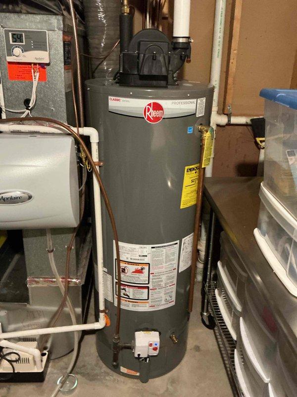 Responded to no hot water call and found Rheem water heater in lockout displaying code 47 error. Successfully reset water heater and restored hot water service to home. Performed biannual plumbing inspection including draining and testing exterior faucets, leak detection throughout property, water heater maintenance and cleaning, sump pump inspection, and laundry hose examination. Inspected utility sink in basement area, noting significant staining and mineral deposits in basin indicating age and wear. Provided estimate for laundry tub replacement due to condition of existing fixture.