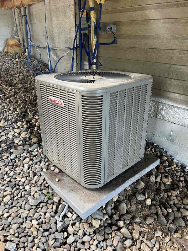 Responded to no cooling complaint on 1-year-old system. Found indoor unit operating but outdoor condenser not receiving power. Traced electrical circuit and discovered contactor not energizing due to loose thermostat wire connections. Located improperly secured wire nuts with masking tape at wall penetration point before furnace connection, likely disturbed during recent painting work. Removed inadequate connections, stripped and re-terminated thermostat wiring with proper wire nuts, and secured connections with electrical tape to prevent future loosening. Verified contactor engagement and confirmed outdoor unit operation. System restored to normal cooling function.