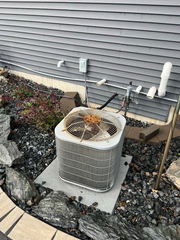 Responded to service call for outdoor air conditioning condenser unit experiencing operational issues. Diagnosed failed dual-value capacitor as the cause of system malfunction. Removed defective capacitor and installed new dual-value secondary start device from stock inventory. Completed full system operational testing following capacitor replacement, verifying proper compressor and fan motor startup, correct amperage draws, and normal cooling cycle operation. Unit restored to proper working condition with all components functioning within manufacturer specifications.