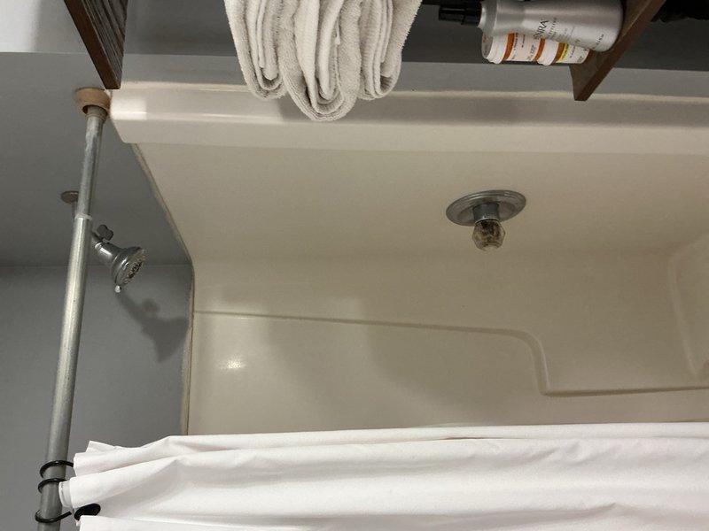 Completed comprehensive plumbing inspection of residential property as part of recurring maintenance program. Inspected toilet tank components including flush valve assembly, flapper seal, fill valve operation, and internal mechanisms; all components found functioning properly with normal wear patterns. Examined bathtub drain assembly, shower fixtures, and water flow; verified proper drainage and fixture operation with no leaks or deficiencies noted.