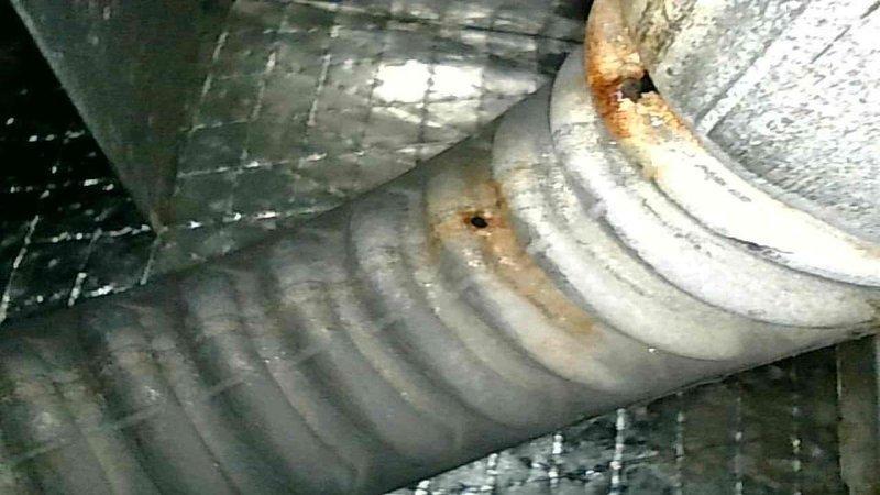 Performed scheduled furnace maintenance tune-up on gas furnace of unknown age. Cleaned flame sensor and verified condensate drain was functioning properly. During heat exchanger inspection, discovered multiple holes in the heat exchanger assembly. Used camera equipment to document damage and showed findings to homeowner, who confirmed air purifier had been detecting carbon monoxide in the home. Red-tagged and removed furnace from service due to safety hazard. Provided homeowner with options for heat exchanger replacement versus complete furnace replacement and arranged for pricing consultation.