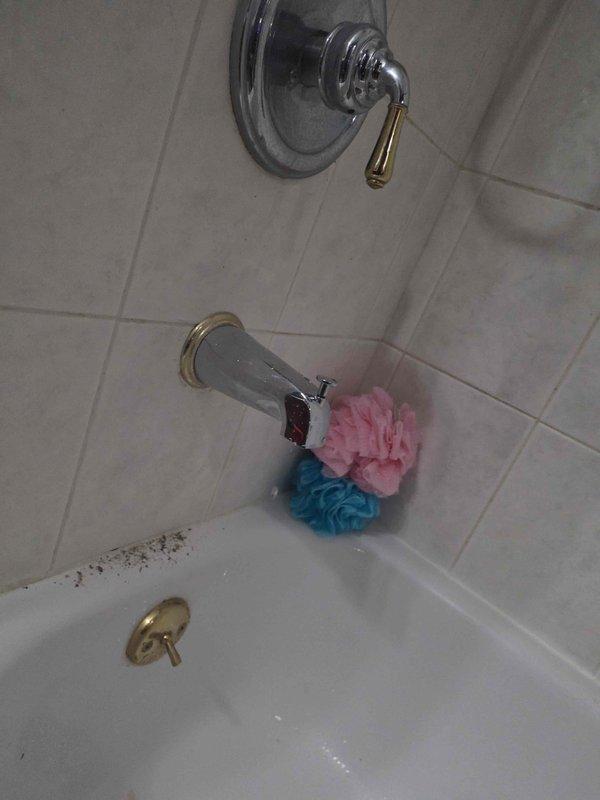 Responded to complaint of dripping tub spout and slow shower drain. Upon inspection, found faulty diverter causing improper seal at shower spout and affecting drainage performance. Removed and replaced defective diverter assembly with new unit. Tested system to verify proper water flow, complete diversion to shower head, and elimination of drip at tub spout. Drainage issue resolved with diverter replacement.
