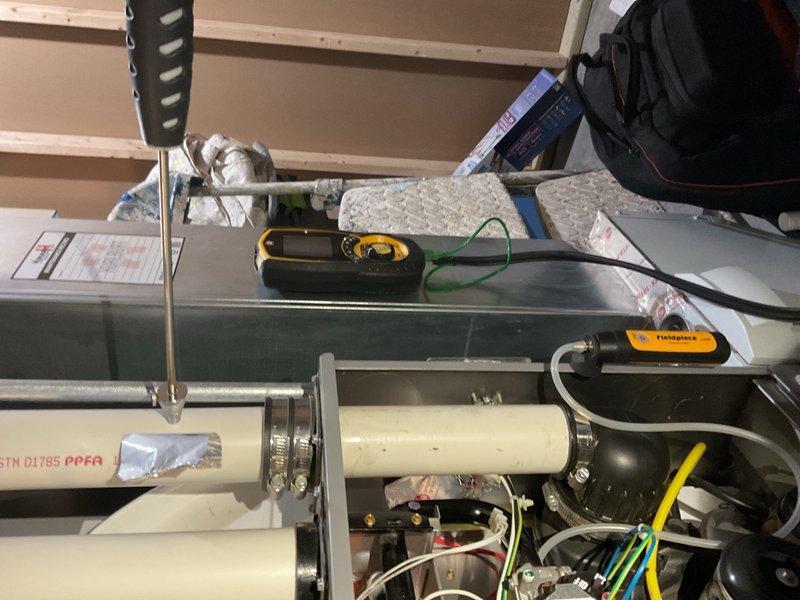 Completed annual maintenance inspection on an 11-year-old ICP furnace under family rewards program. System operated normally with all electrical components testing within acceptable parameters: inducer capacitor rated 5 µF tested at 4.970 µF, and blower motor capacitor rated 15 µF tested at 15.6 µF. Performed combustion analysis which showed initial CO reading of approximately 110 ppm, stabilizing to 62 ppm after 15 minutes of runtime. Identified environmental concerns including two cat litter boxes positioned near the furnace and visible gaps in the furnace cabinet allowing dust and debris infiltration into the unit. Evidence of cat litter contamination observed inside cabinet with potential impact on burner and heat exchanger areas, though no operational failure present at time of service. Recommended sealing all cabinet gaps, relocating litter boxes away from equipment, improving housekeeping practices around furnace area, and monitoring combustion readings during future maintenance