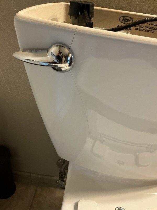 Responded to service call for cracked toilet tank requiring immediate replacement. Removed existing failed toilet and installed new Gerber Viper elongated comfort height toilet. Addressed uneven floor condition by shimming toilet to ensure proper level and stable installation. Connected water supply line and performed leak testing with five consecutive flushes to verify proper operation and confirm no leaks at tank, bowl, or supply connections. Installation completed successfully with unit functioning properly.