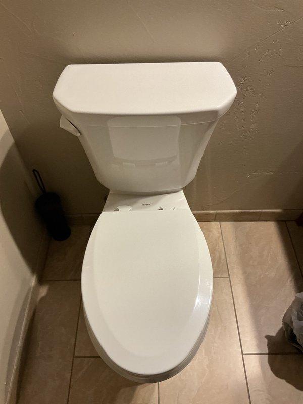 Responded to service call for cracked toilet tank requiring immediate replacement. Removed existing failed toilet and installed new Gerber Viper elongated comfort height toilet. Addressed uneven floor condition by shimming toilet to ensure proper level and stable installation. Connected water supply line and performed leak testing with five consecutive flushes to verify proper operation and confirm no leaks at tank, bowl, or supply connections. Installation completed successfully with unit functioning properly.
