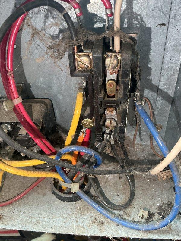 Responded to no cooling complaint on 38-year-old air conditioning system. Upon arrival, unit was operational following customer reset of system after overnight shutdown. Diagnosed failing contactor exhibiting excessive buzzing and intermittent operation, which caused system shutdown requiring manual reset. Observed compressor drawing high starting amperage, indicating motor wear consistent with unit age. Electrical connections showed significant corrosion, dust accumulation, and environmental degradation. System currently operational but contactor failure imminent and compressor nearing end of service life. Recommended full system replacement due to age and condition of components. Scheduled replacement estimate appointment.