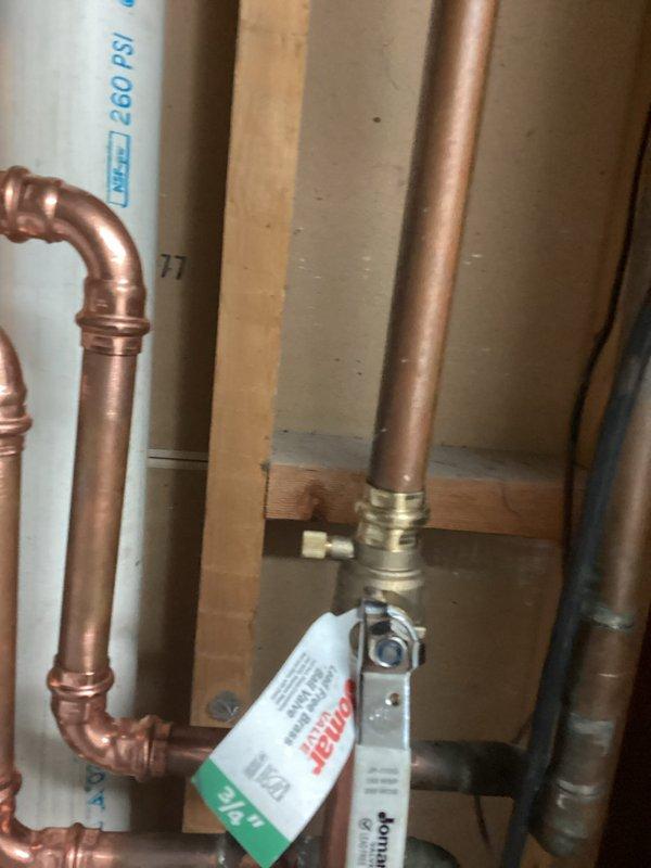 Replaced house side valve and indoor shut-off valve for exterior faucet. Both the house side valve and spigot valve were successfully replaced and tested for proper operation. Work completed in basement utility area with copper piping connections properly secured.