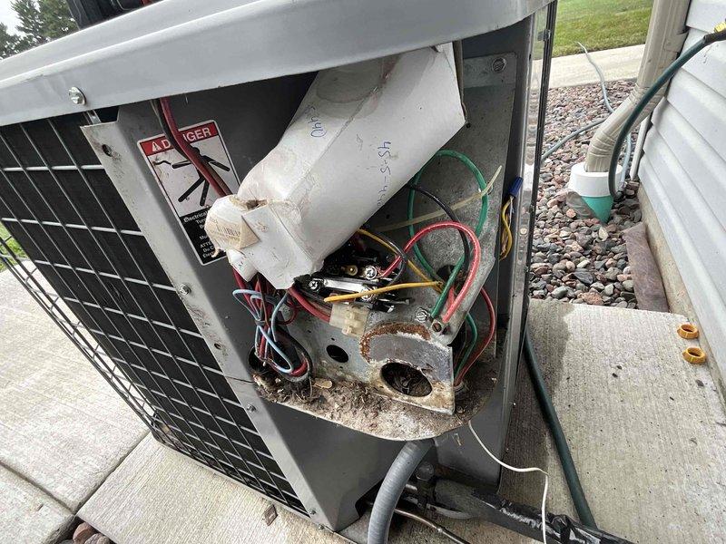Conducted comprehensive evaluation of existing HVAC system for complete replacement estimate. Inspection revealed outdoor air conditioning unit with severe electrical component deterioration, including extensive rust and corrosion on internal mounting plate and terminal connections. Documented grounded wiring condition in AC unit with photographic evidence showing compromised electrical integrity and moisture damage to critical components. Prepared detailed replacement bid for both air conditioning system and furnace to address safety concerns and restore proper system operation.