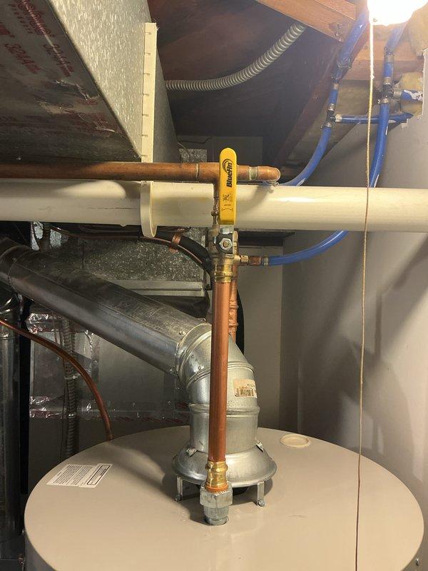 Completed full replacement of 50-gallon natural gas standard vent water heater in attic crawl space, removing existing unit and installing new like-for-like equipment. Connected copper supply lines to tank with proper pressure relief valve assembly and installed gas control valve with pilot safety system. Established all water connections, verified proper venting through existing PVC flue system, and tested gas line connections for leaks. Performed system startup, ignited pilot light, adjusted temperature controls, and confirmed proper operation of all safety mechanisms. Identified main water valve requiring replacement and provided proposal for future service. All work completed per specifications with system fully operational and tested.