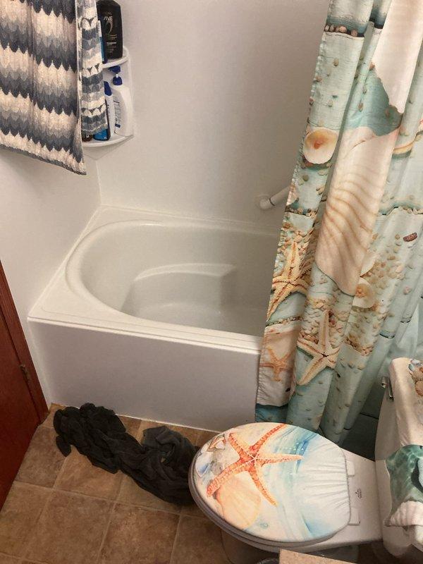 Responded to active water leak originating from main bathroom in split-level residence. Leak penetrated through garage drywall and caused basement flooding. Assessed damage and determined drywall removal would be necessary to access source of leak. Documented conditions with photographs of bathroom area. Customer elected to proceed with restoration services through their insurance company's preferred vendor.