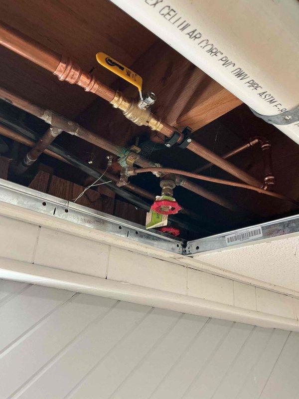 Responded to a badly leaking hose bibb at the rear of the property. Upon inspection, determined the existing outdoor spigot had failed and required full replacement. Accessed the water supply lines through the ceiling cavity, removed the defective hose bibb, and installed a new frost-free hose bibb with proper copper connections and shutoff valve. Tested the new fixture for proper operation and verified no leaks at connection points.