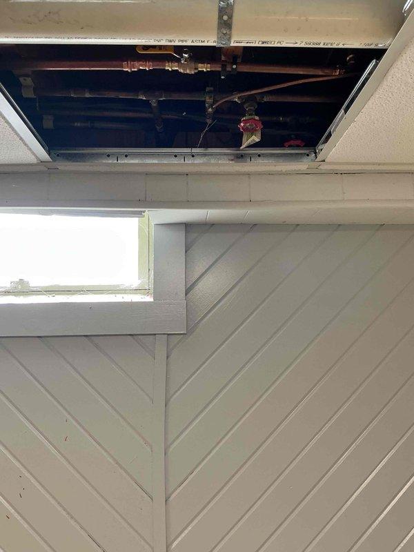 Responded to a badly leaking hose bibb at the rear of the property. Upon inspection, determined the existing outdoor spigot had failed and required full replacement. Accessed the water supply lines through the ceiling cavity, removed the defective hose bibb, and installed a new frost-free hose bibb with proper copper connections and shutoff valve. Tested the new fixture for proper operation and verified no leaks at connection points.